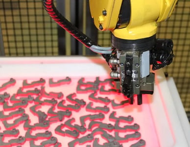 AWR success story, Glacier Tool & Die, robot gripper picking up parts