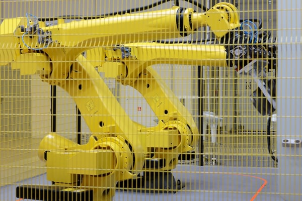 two yellow cnc machine tending robots for shop automation